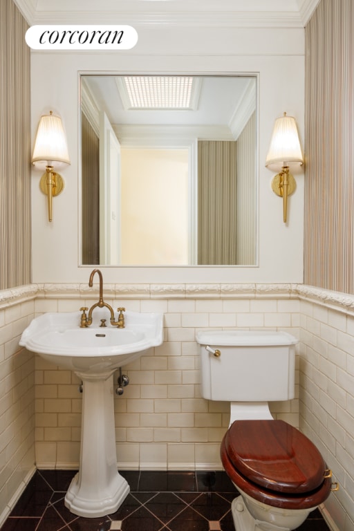 bathroom featuring toilet and tile patterned flooring