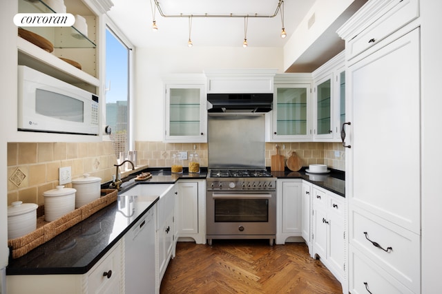 kitchen featuring white appliances, white cabinets, tasteful backsplash, sink, and dark parquet floors