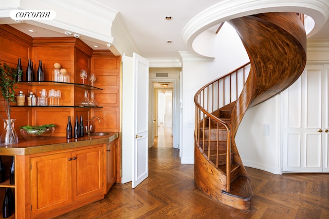 bar with crown molding, dark parquet flooring, and sink