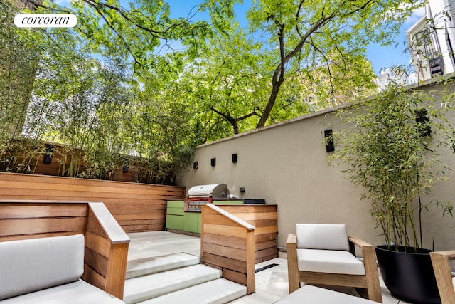 wooden terrace featuring a patio and grilling area