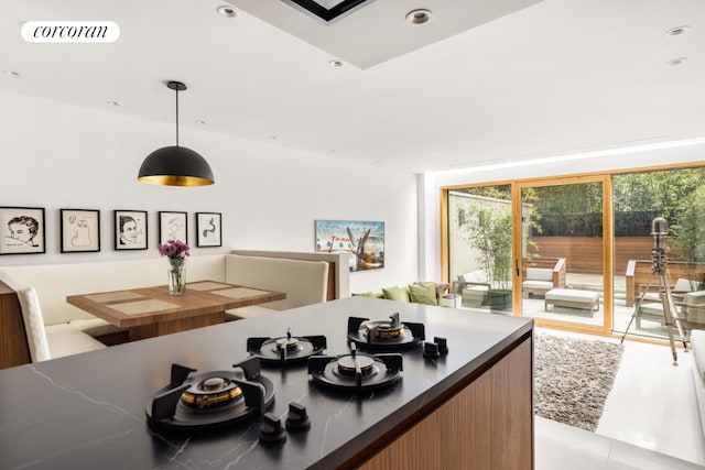 kitchen featuring light tile patterned flooring and decorative light fixtures