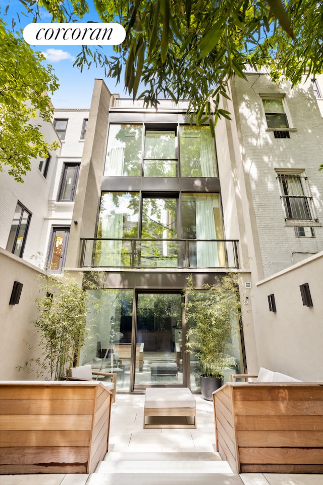 248 W 71st St, New York City, NY 10023 - rear view of property with a balcony, a patio area, and an outdoor hangout area