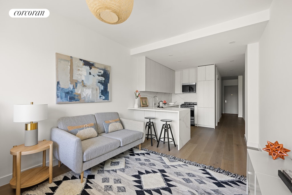 living room featuring visible vents and dark wood-style flooring