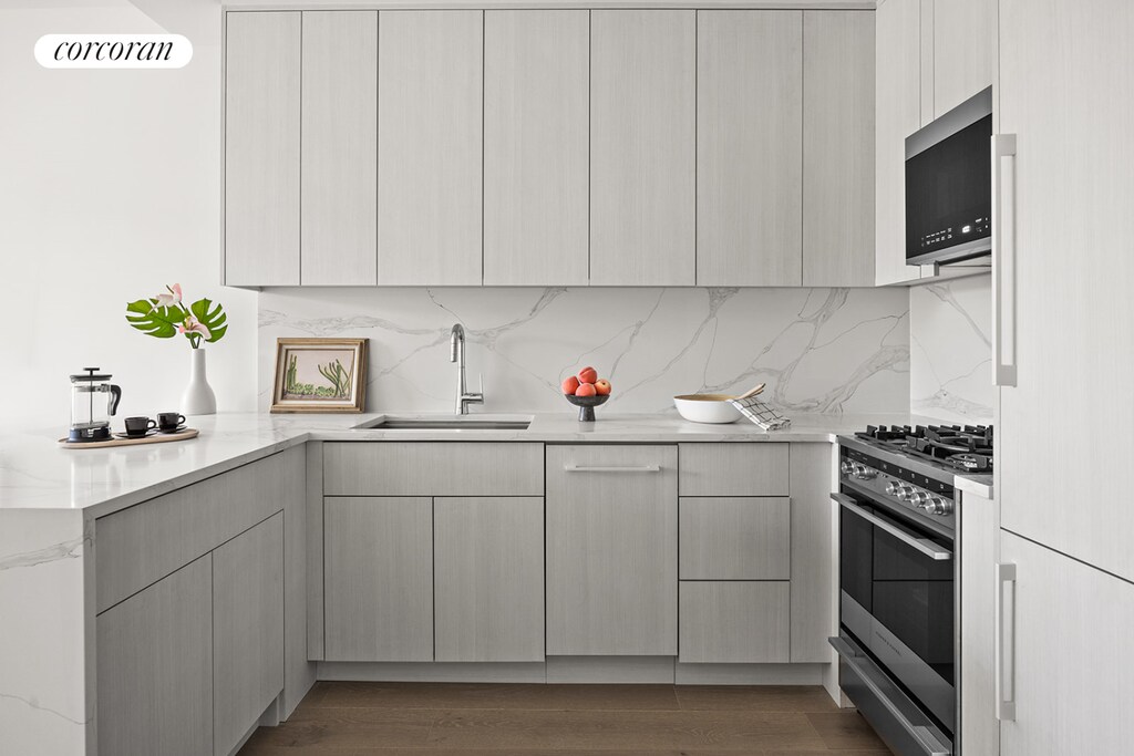 kitchen featuring modern cabinets, appliances with stainless steel finishes, and a sink