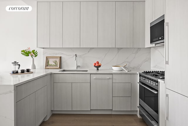 kitchen featuring modern cabinets, a sink, and stainless steel appliances