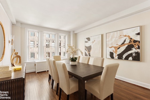 dining area with hardwood / wood-style floors, radiator, and baseboards