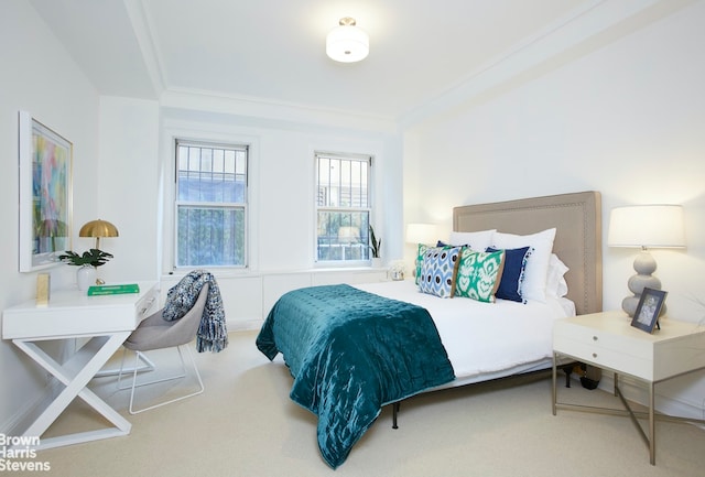 carpeted bedroom featuring crown molding