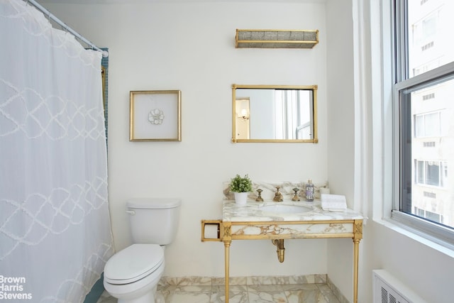 bathroom with curtained shower, toilet, radiator, and sink