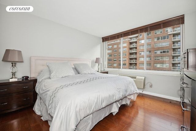 bedroom with visible vents, baseboards, and hardwood / wood-style floors