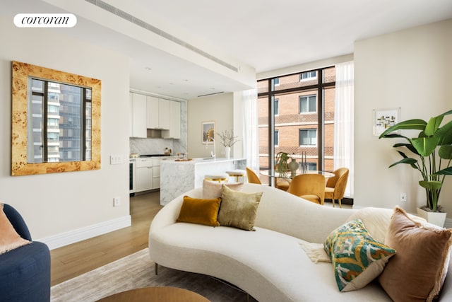 interior space with wood-type flooring, floor to ceiling windows, and access to outside