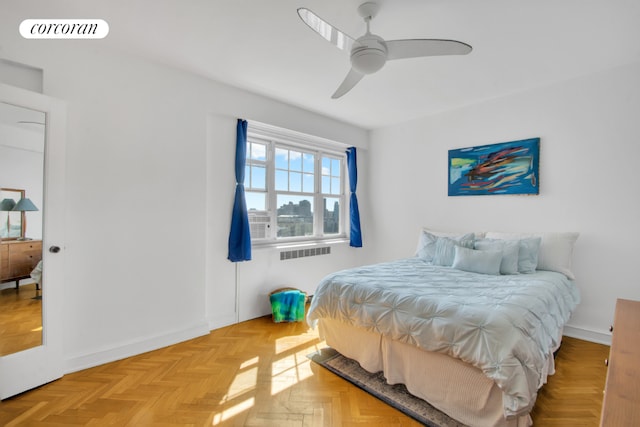 bedroom with ceiling fan and light parquet flooring