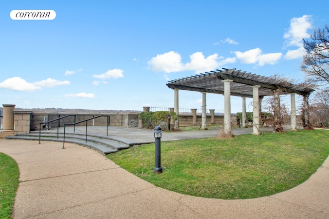 view of property's community with a yard and a pergola