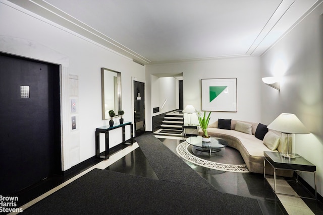 living room with ornamental molding and elevator