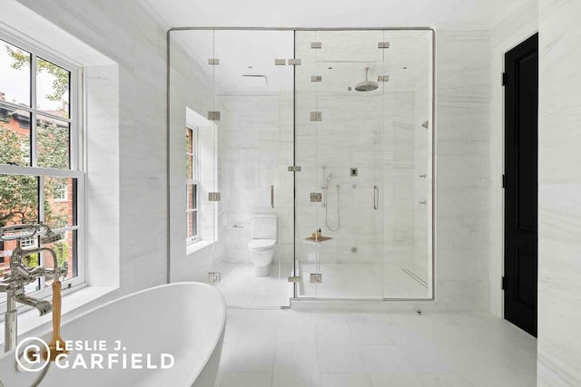 bathroom featuring tile patterned floors, tile walls, toilet, and independent shower and bath