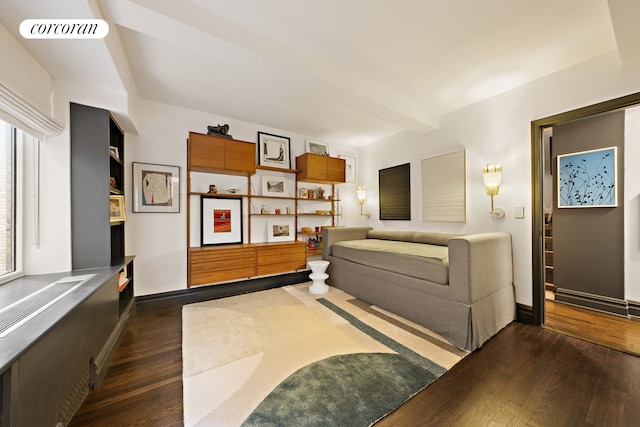 living area with plenty of natural light, baseboards, visible vents, and dark wood-style flooring