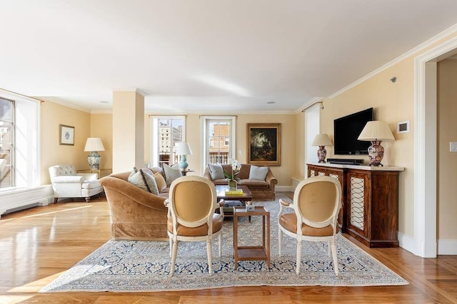 living room with crown molding, plenty of natural light, and light wood-type flooring