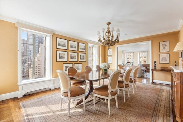 dining area featuring an inviting chandelier, ornamental molding, and light parquet flooring