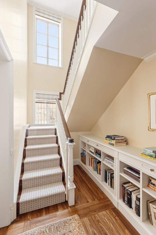 staircase with parquet floors and ornamental molding