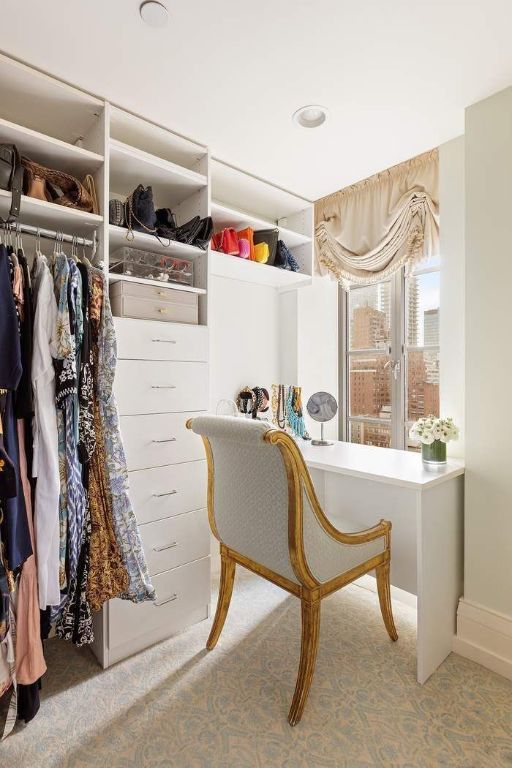 walk in closet featuring light carpet