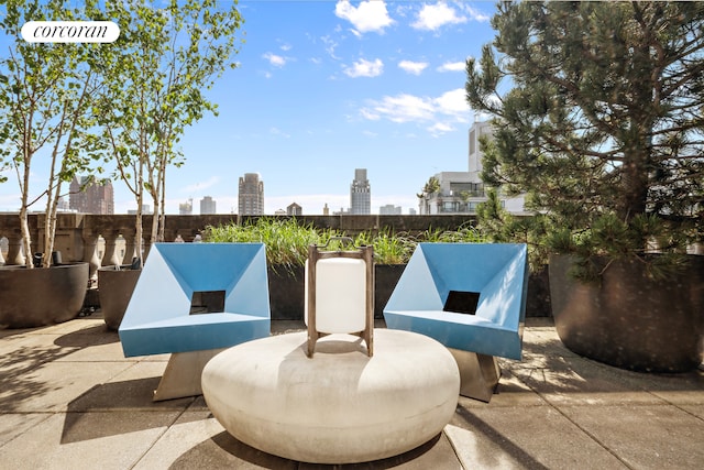 view of patio with a city view and fence