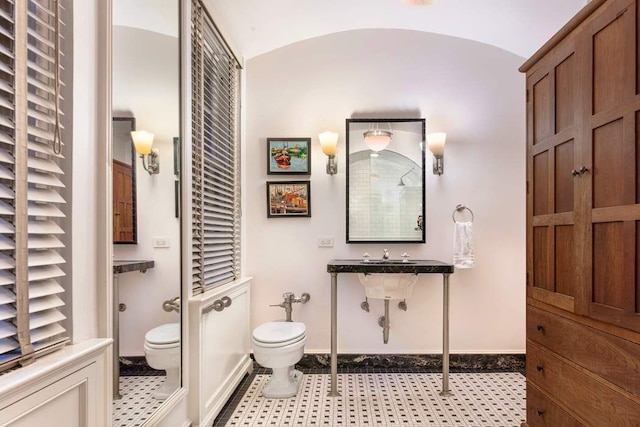 bathroom with tile patterned floors, toilet, and vaulted ceiling