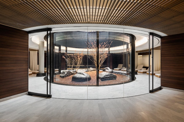 wine cellar with wood finished floors and wooden walls