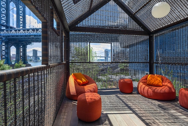 sunroom with vaulted ceiling and a city view