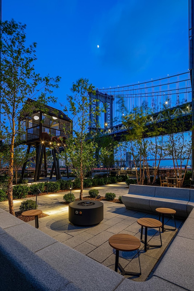 view of patio / terrace with playground community and an outdoor fire pit