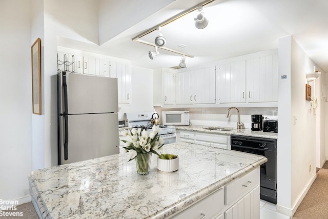 kitchen with light colored carpet, light stone counters, white cabinets, white appliances, and a sink