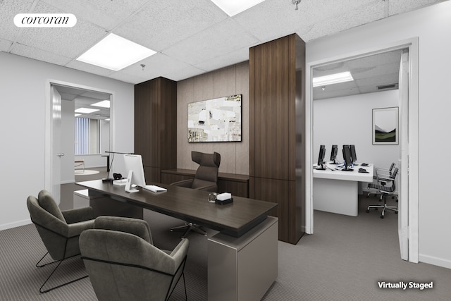 office space featuring light carpet, wooden walls, visible vents, and a drop ceiling