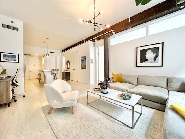 living room with a chandelier and light hardwood / wood-style flooring