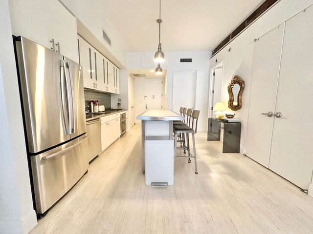 living room with a chandelier and light hardwood / wood-style flooring