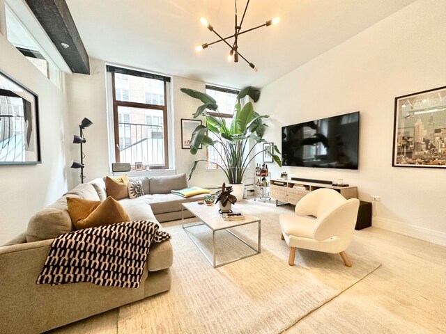 living room featuring a notable chandelier and light hardwood / wood-style flooring