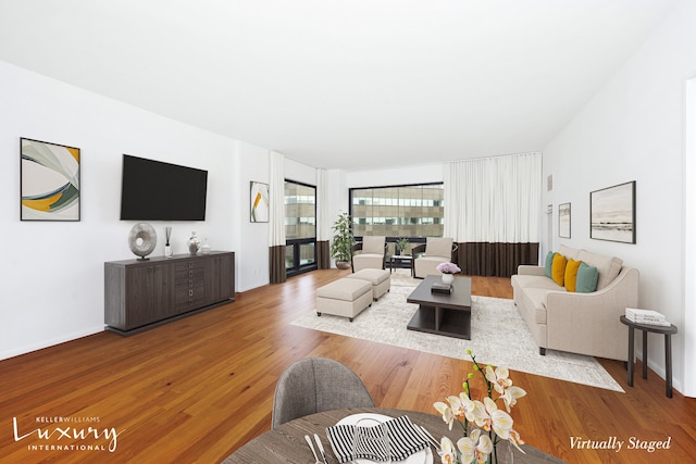 living room featuring baseboards and wood finished floors