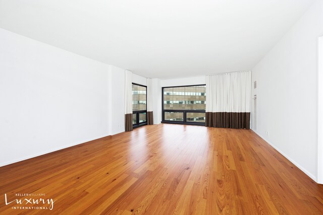 interior space featuring light wood-style floors and baseboards