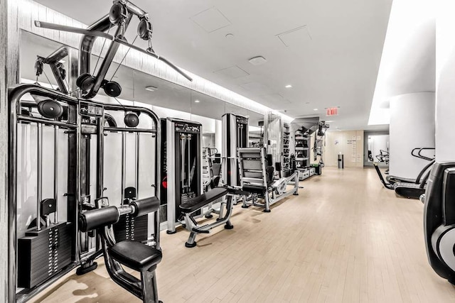 workout area with light hardwood / wood-style floors