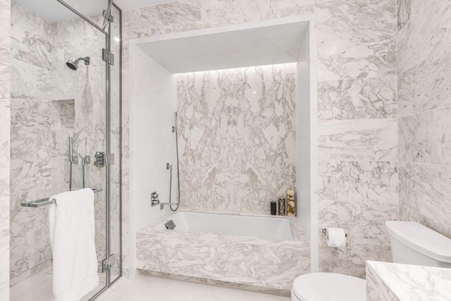 bathroom featuring toilet, tile walls, and shower with separate bathtub