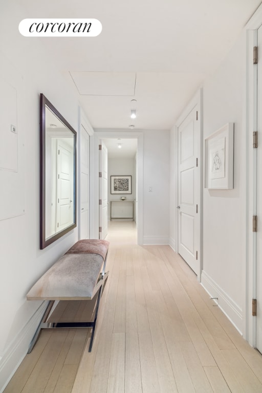 hallway with light hardwood / wood-style flooring