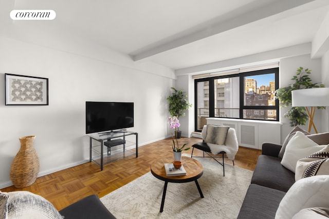 living room with visible vents, beamed ceiling, and baseboards