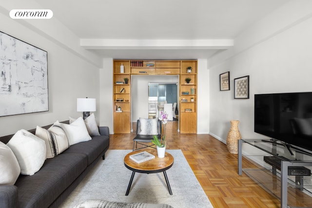 living room with baseboards, visible vents, and beamed ceiling