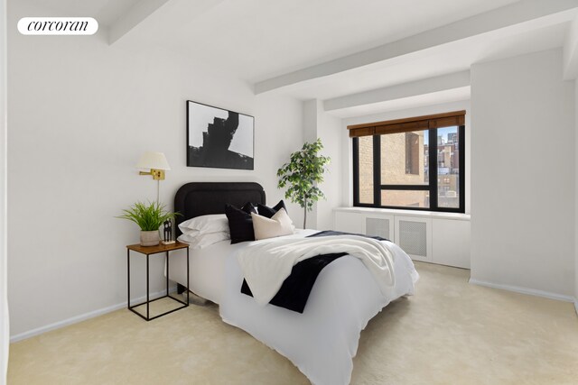 bedroom with baseboards, visible vents, beam ceiling, and light colored carpet