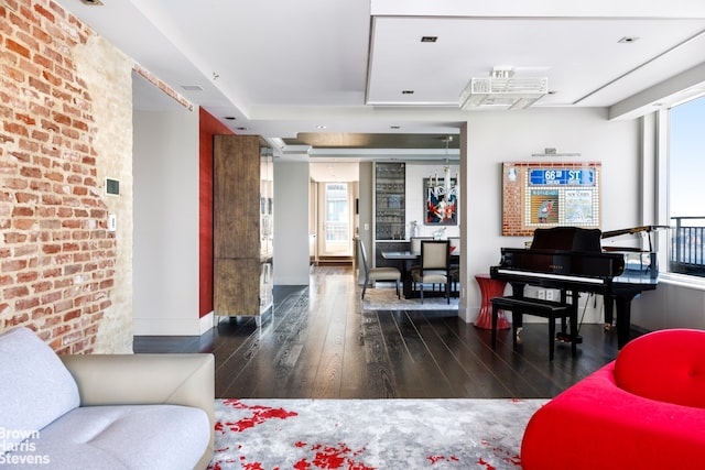 interior space with dark wood-type flooring and brick wall