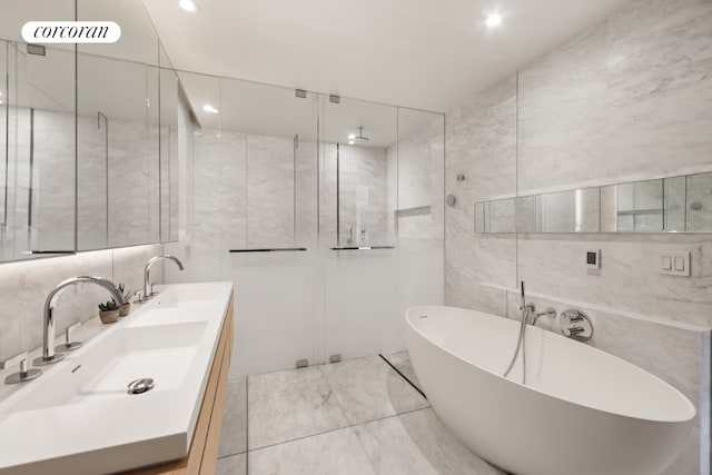 bathroom featuring independent shower and bath, tile walls, and vanity