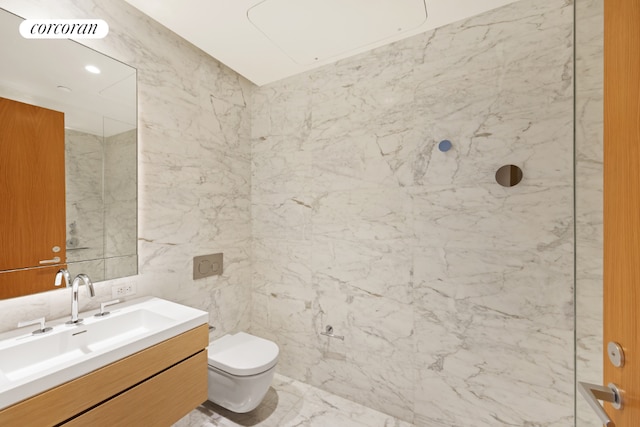 bathroom featuring tile walls, vanity, and toilet