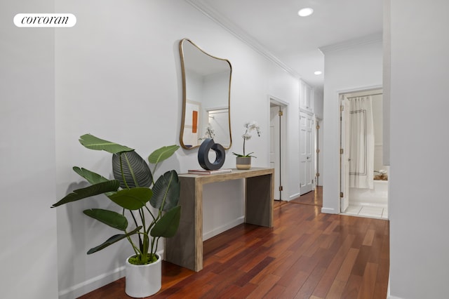 hallway with crown molding, baseboards, wood finished floors, and recessed lighting