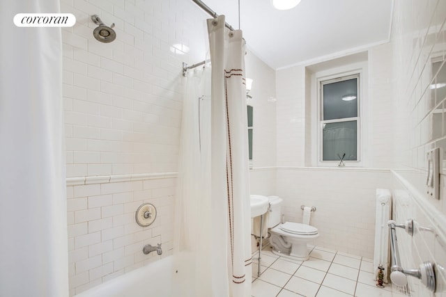 bathroom with shower / tub combo, toilet, tile patterned flooring, crown molding, and tile walls