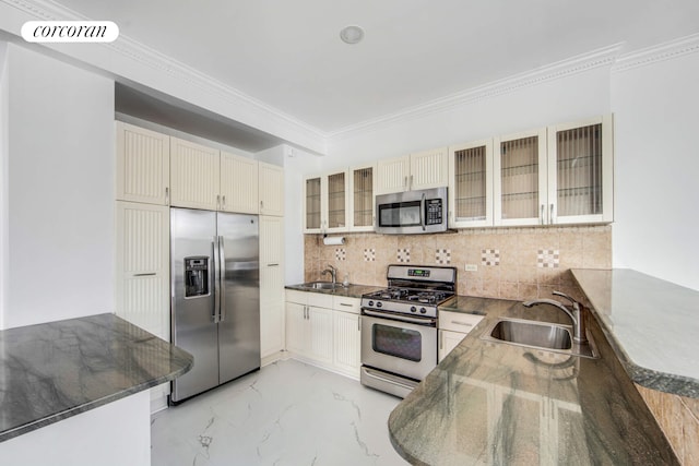 kitchen featuring marble finish floor, ornamental molding, stainless steel appliances, and a sink