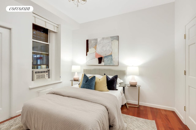 bedroom with hardwood / wood-style floors and cooling unit