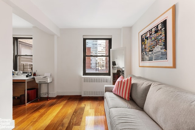 living room featuring hardwood / wood-style floors and radiator heating unit