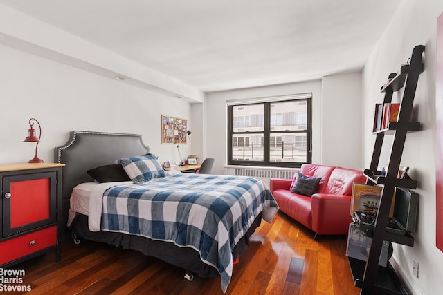 bedroom with radiator and dark wood-type flooring